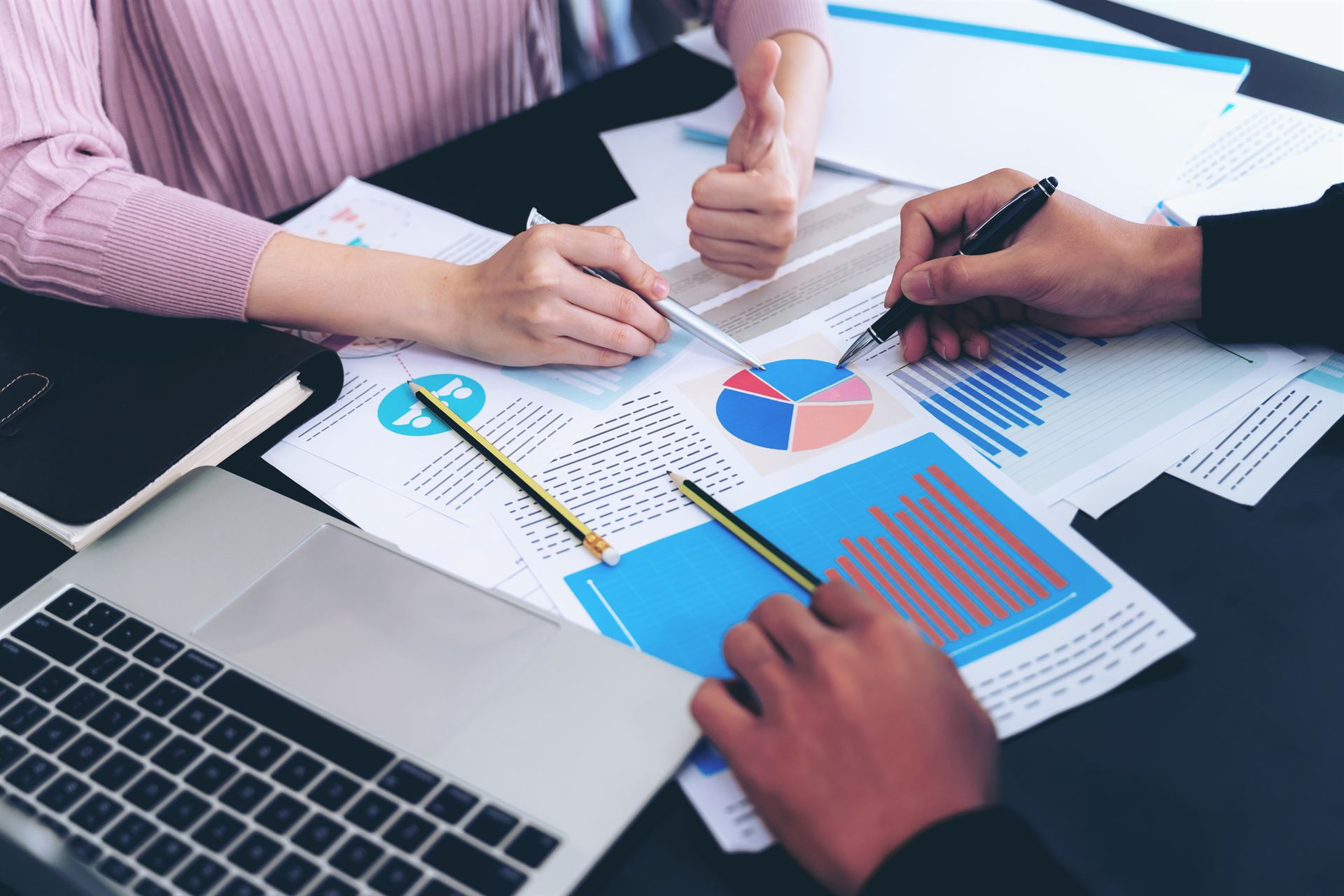 Auditors reviewing charts and operational reports